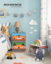 Tiger and fox toy boxes stacked in a child's blue bedroom beside a bed and soft toys