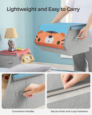 Hand lifting the tiger toy box by its side handle to show how light it is to carry