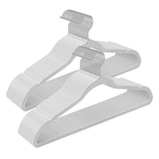 Two stacks of white velvet hangers with metal swivel hooks