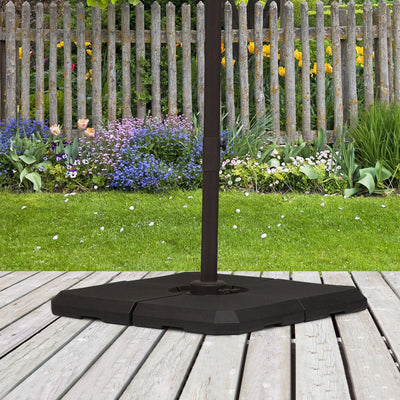 Parasol base weights assembled beneath a cross-base parasol stand on a garden deck