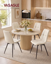 Four light beige velvet dining chairs around a round table in a bright kitchen
