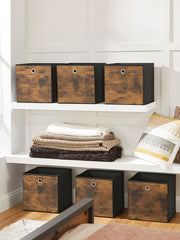 Six cubes lined up along two white alcove shelves beside folded blankets