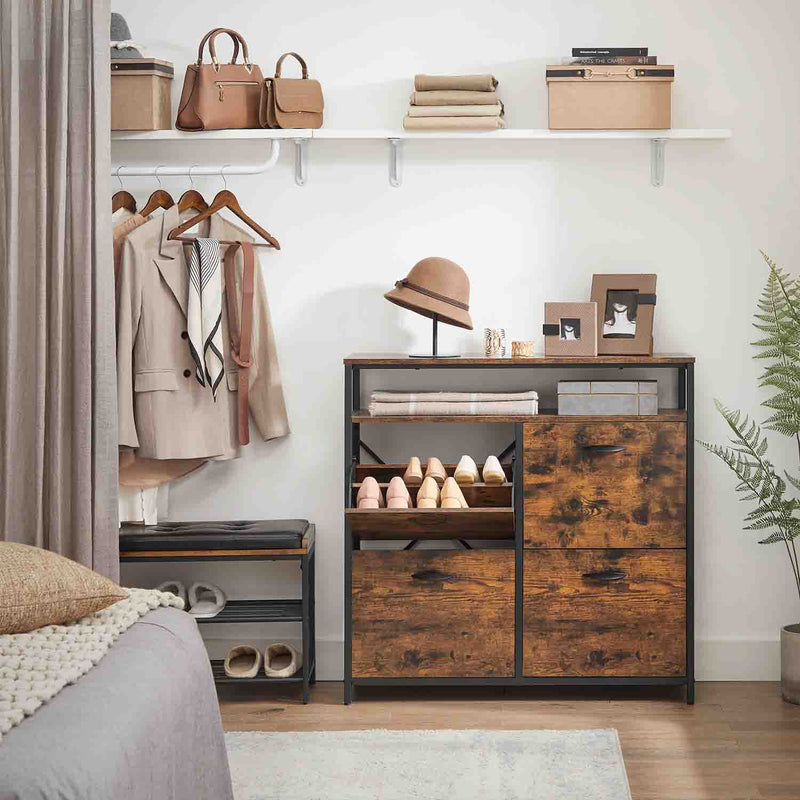 Rustic brown 4 door shoe cabinet in a bedroom with clothes hanging on a rail behind