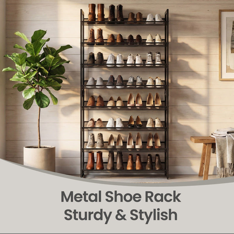 Shoe rack holding boots and brogues against a wood-panelled wall beside a potted fig tree