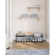 Songmics shoe shelf in a bedroom entryway below wall-mounted shelves
