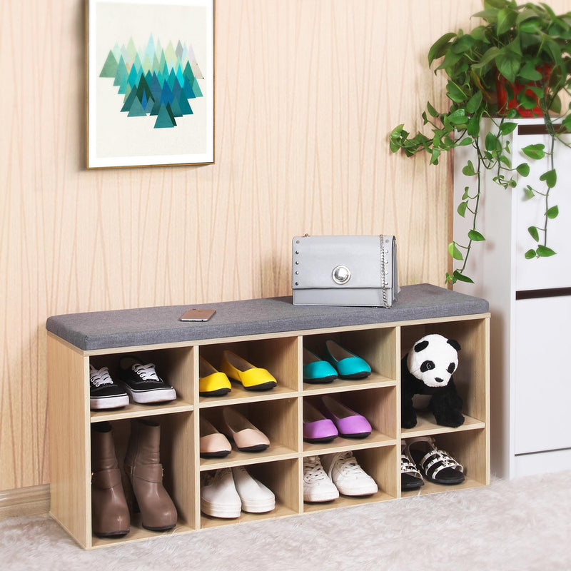 Natural shoe bench in a hallway holding shoes, boots, a handbag and a soft toy