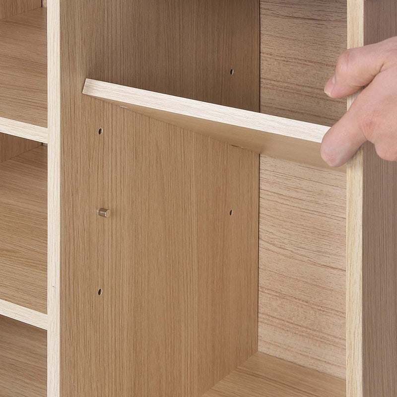 Close-up of an adjustable side shelf being fitted into the peg holes inside a compartment