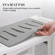 Hand lifting the removable grey EVA seat pad off the white shower stool