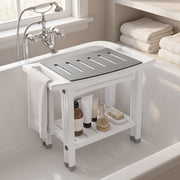 Shower stool placed inside a white bath with a towel over the side and toiletries on the shelf