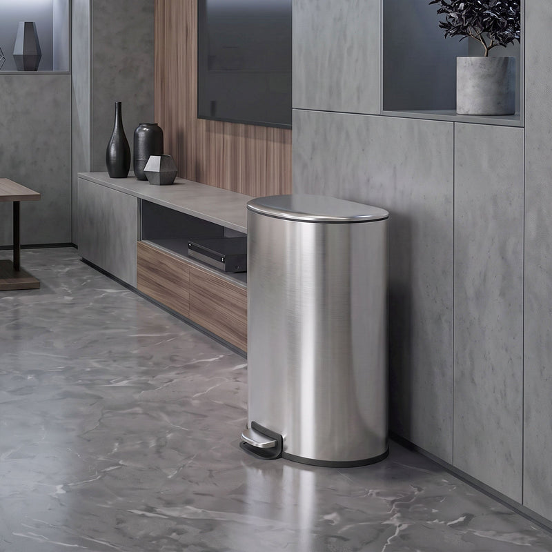 Silver pedal bin standing beside a media unit in a grey living room