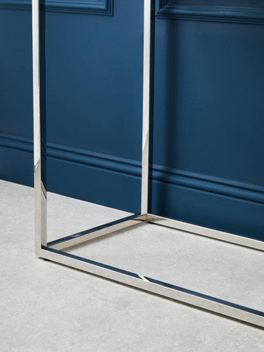 Glass console table shown with storage baskets under the open base