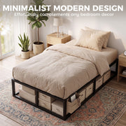 Bed frame styled with cream bedding and fabric storage boxes tucked underneath in a bright bedroom