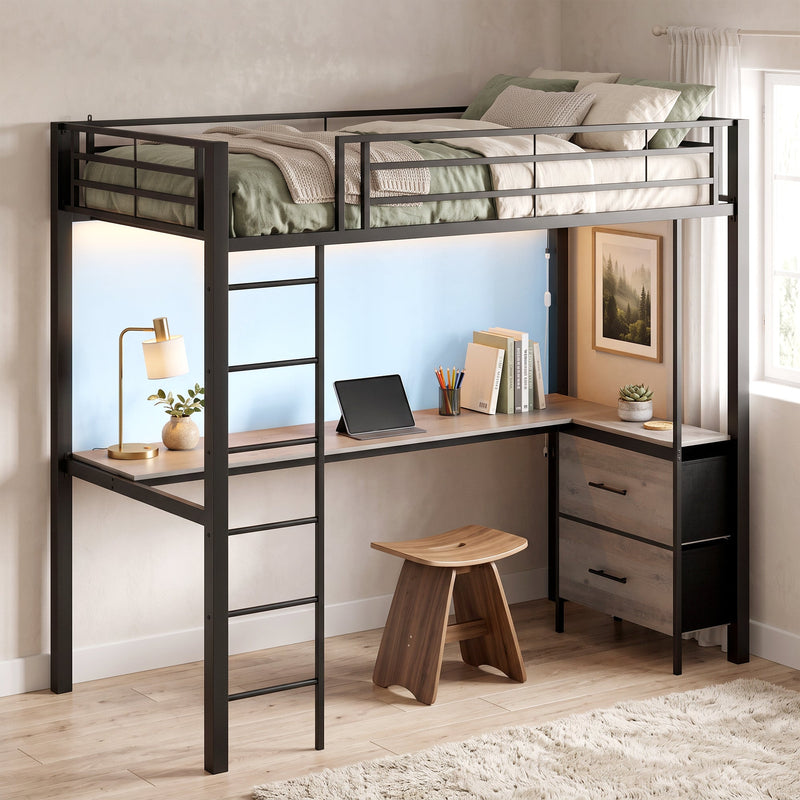Loft bed made up with green bedding, a tablet on the desk and a stool beneath