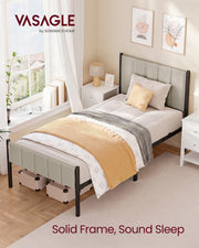 The single bed frame made up in a bright bedroom beside a window and bedside table, captioned solid frame, sound sleep