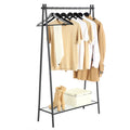 Black single rod garment rack holding shirts and a jacket with boots on the mesh shelf