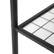 Close-up of the mesh bottom shelf with its plastic panel and black steel leg