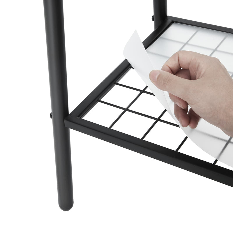 Hand lifting the plastic panel from the mesh bottom shelf of the garment rack