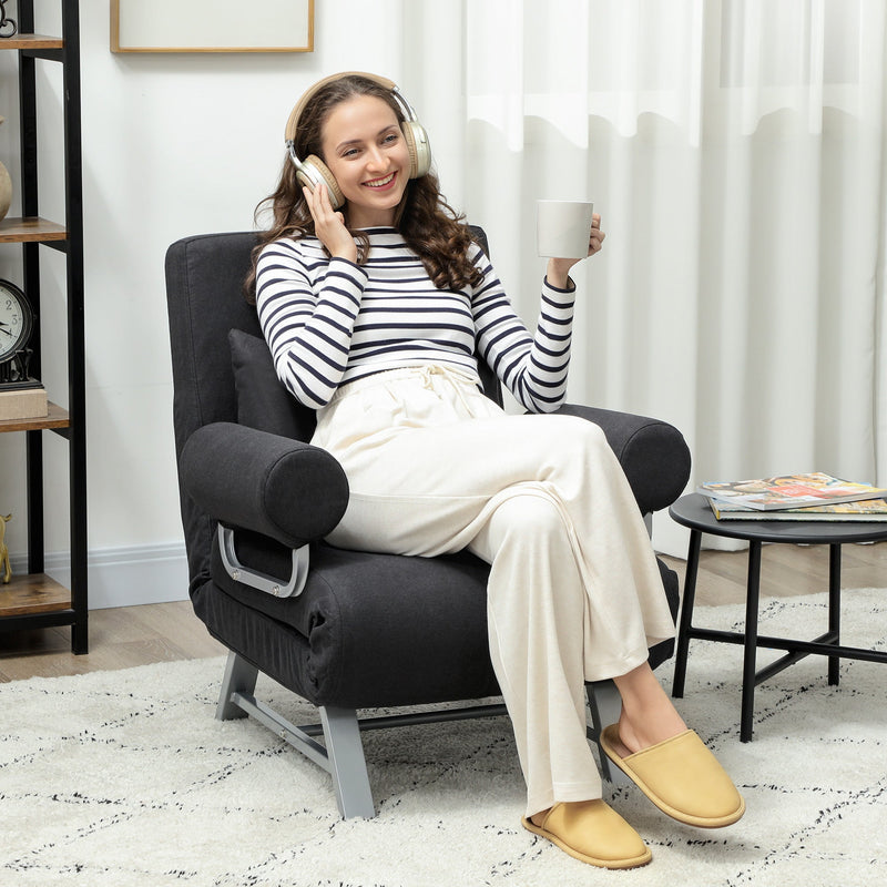 Woman relaxing in the black sofa bed chair in a living room setting