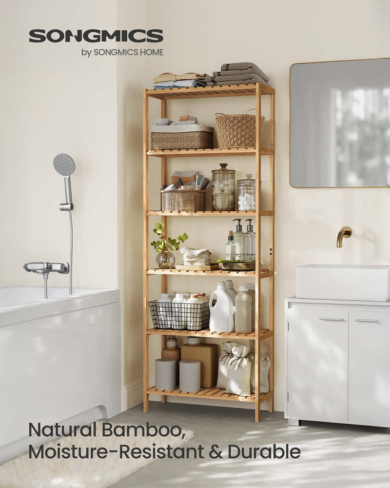 Bamboo storage shelf styled in a bathroom with towels and toiletries
