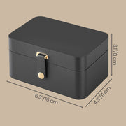 Closed slate grey jewellery case on an angled studio background labelled with dimensions 16cm width, 11cm depth and 8cm height
