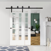 Sliding barn door hardware carrying two white glazed doors into a bedroom
