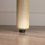 Close-up of the cabinet's adjustable levelling foot on a wood floor