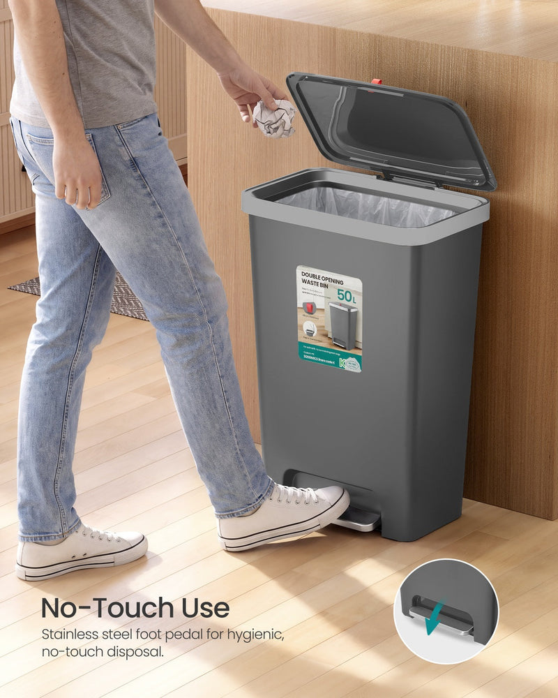 Man using the foot pedal on the grey 50L bin for no-touch disposal