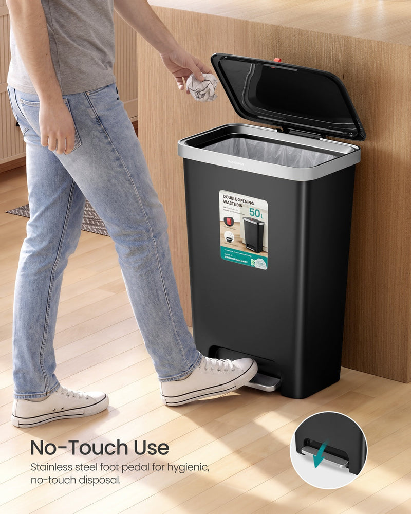 Man using the foot pedal on the black 50L bin for no-touch disposal