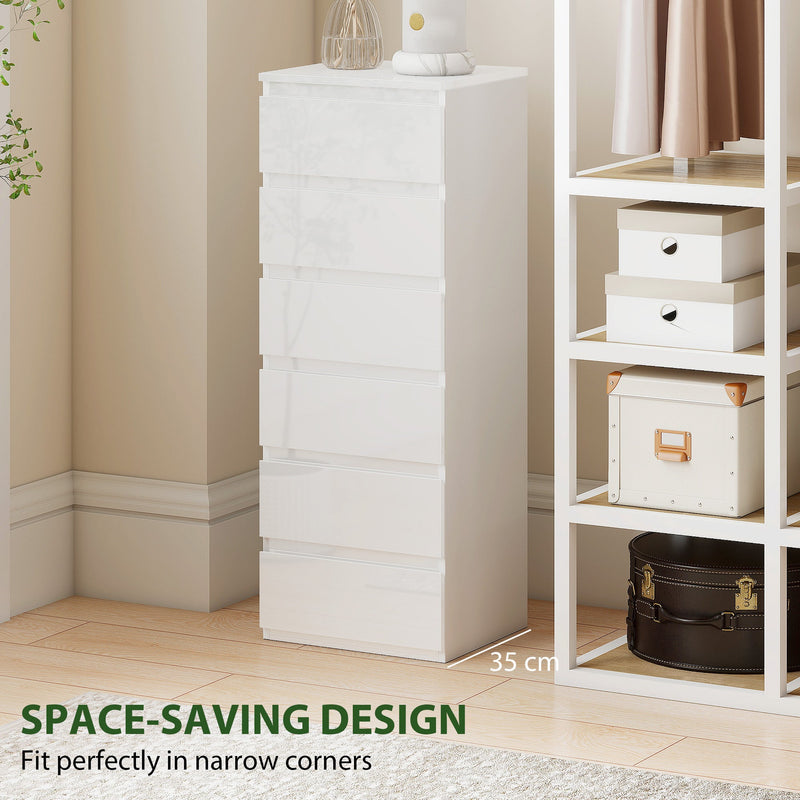 White slim chest of drawers standing next to open shelving with storage boxes