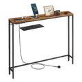 Slim rustic brown console table on a black steel frame with a built-in power strip charging a phone