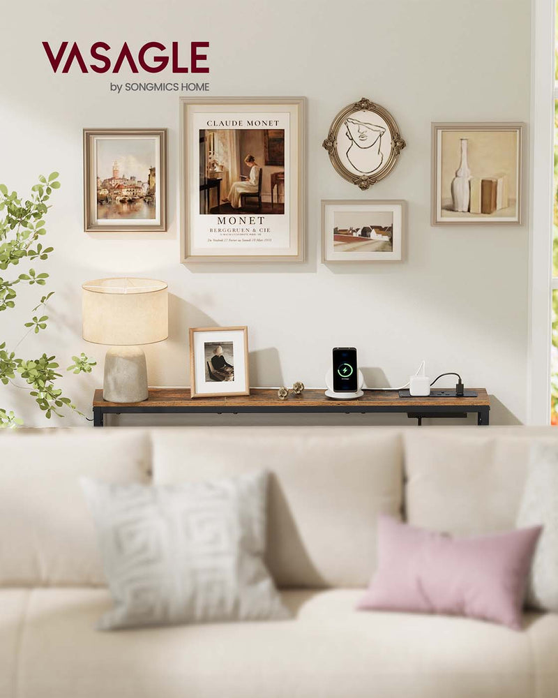 Vasagle console table behind a cream sofa with a table lamp, photo frame and gallery wall