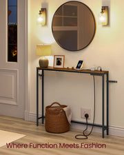 Narrow console table in a hallway under a round mirror with a lamp and a woven basket beneath