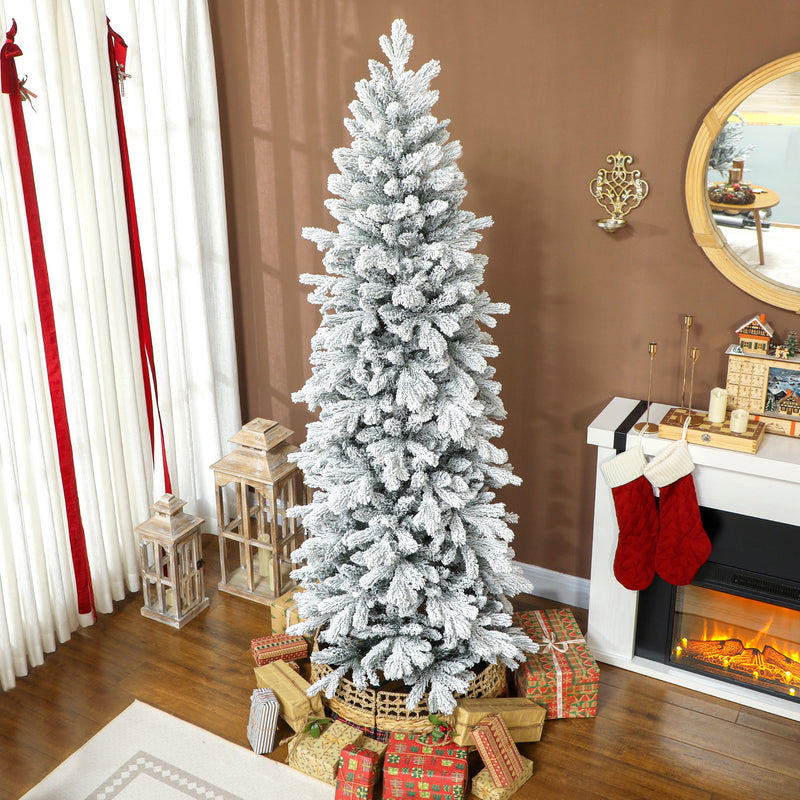 7ft slim flocked pencil Christmas tree beside a fireplace with red stockings, a round mirror and presents
