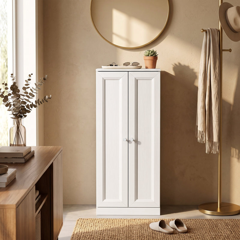 White bathroom cabinet used as a hallway storage unit beneath a round mirror