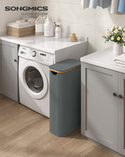 Grey slim hamper standing in the gap beside a washing machine in a utility room