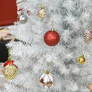 Close-up of white branch tips hung with red, silver and gold baubles
