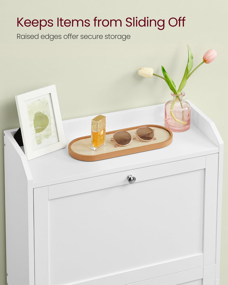 Raised-edge top shelf of the white shoe cabinet holding a photo frame, tray and vase