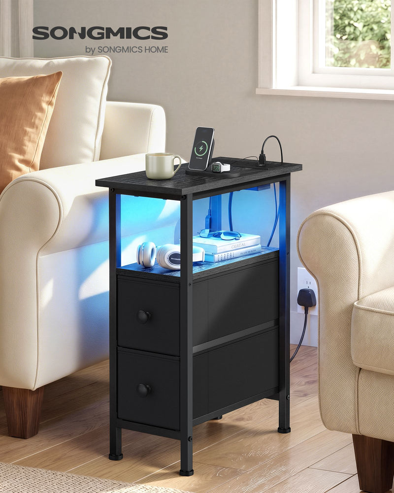 Slim black side table beside a cream armchair with blue LED light under the top
