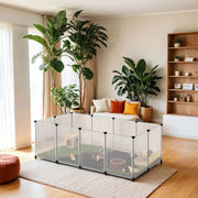 White plastic small animal cage set up in a living room with guinea pigs playing inside