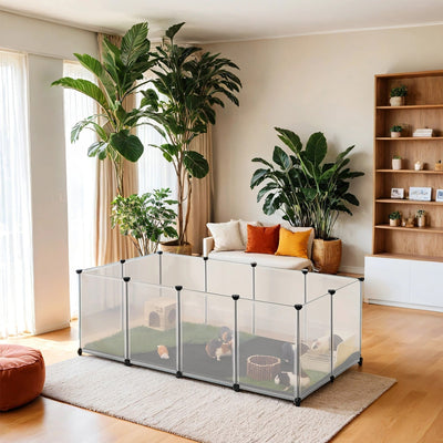 White plastic small animal cage set up in a living room with guinea pigs playing inside