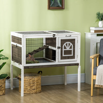 Hutch styled indoors on its legs with a rabbit inside and a wicker basket underneath