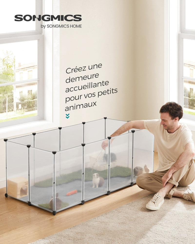 Man reaching into the assembled white pet playpen set up on a bedroom floor
