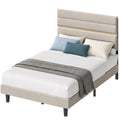 Beige upholstered small double bed frame with a padded headboard and gold-tone trim, shown with white bedding