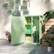 Green shed with the door open below a wall of succulent frames, showing shelves and boots inside