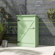 Green wooden shed closed against a dark slatted fence with trailing plants and a metal bucket