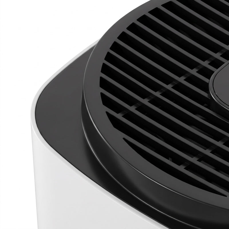 Close-up of the black top grille on the white air purifier body