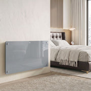 Grey 1500W panel heater wall-mounted in a modern bedroom
