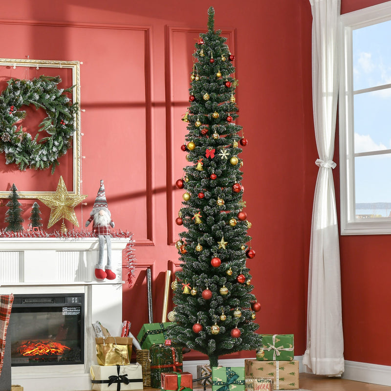 Snow-dipped 7.5ft tree with red and gold baubles in a red room beside a white fireplace