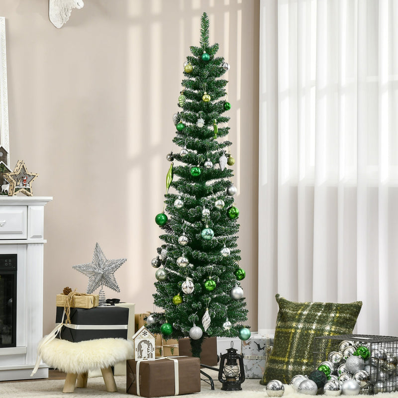Snow-dipped pencil Christmas tree with green and silver baubles beside a white fireplace