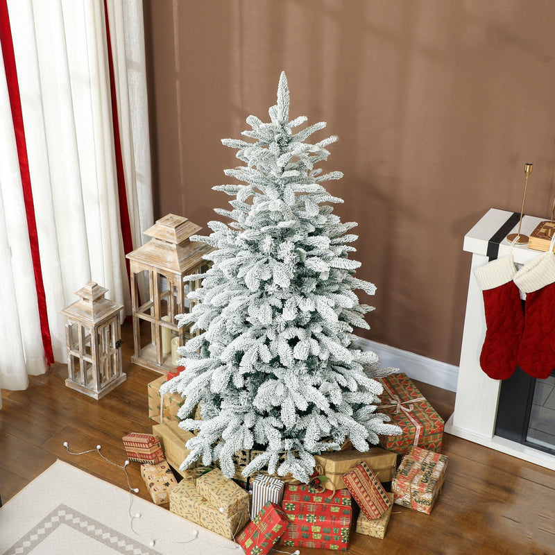 5ft snow flocked tree surrounded by wrapped presents beside a fireplace